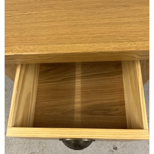 1343 - A modern light oak Sherbourne lamp table with single drawer and undershelf. Metal cup handle. Approx... 