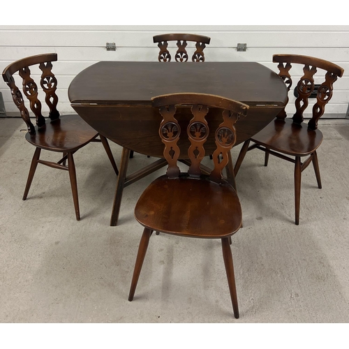 1345 - A Mid century Ercol drop leaf dining table together with a set of 4 Ercol dining chairs. Unmarked ov... 