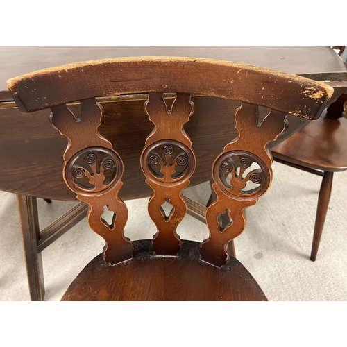 1345 - A Mid century Ercol drop leaf dining table together with a set of 4 Ercol dining chairs. Unmarked ov... 