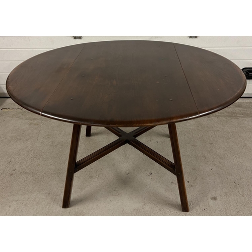 1345 - A Mid century Ercol drop leaf dining table together with a set of 4 Ercol dining chairs. Unmarked ov... 