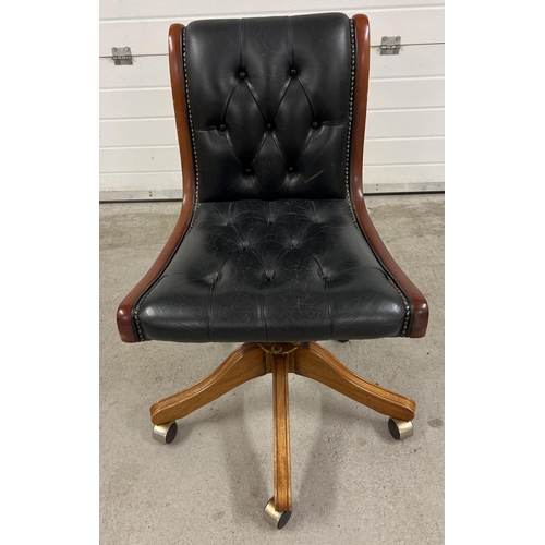 1347 - A vintage Mekanikk, Norway wood framed, 5 footed swivel chair with studded leather upholstery. Raise... 