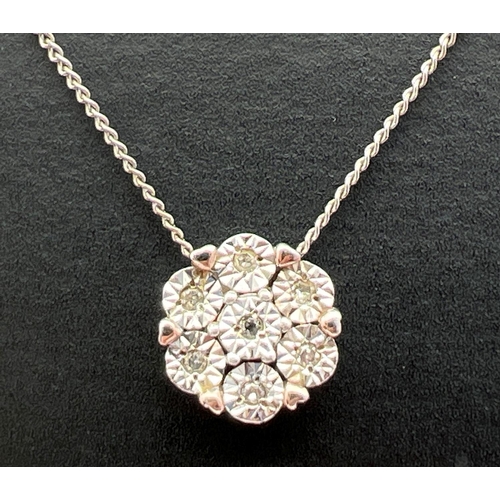 1061 - A small silver and white 9ct gold flower design sliding pendant necklace, set with 7 small round cut... 