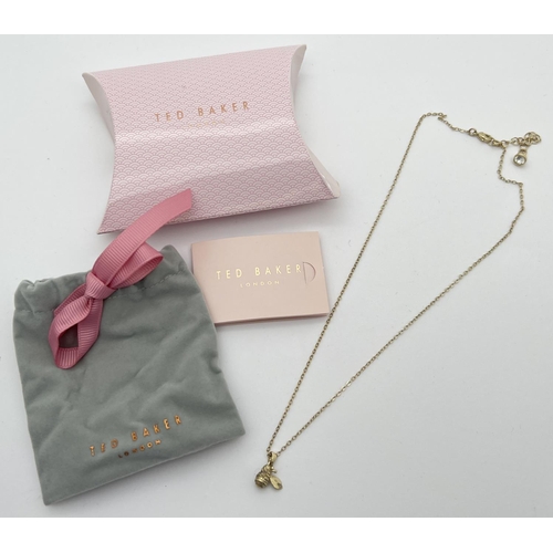 1062 - A gold tone bumble bee pendant necklace by Ted Baker, complete with original pouch, box and care car... 