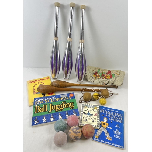 1281 - A collection of juggling equipment and books. To include lightweight juggling batons, wooden batons,... 