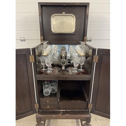 1348 - A vintage dark wood drinks/cocktail cabinet with glass and bottle compartments, 2 drawers and a coll... 