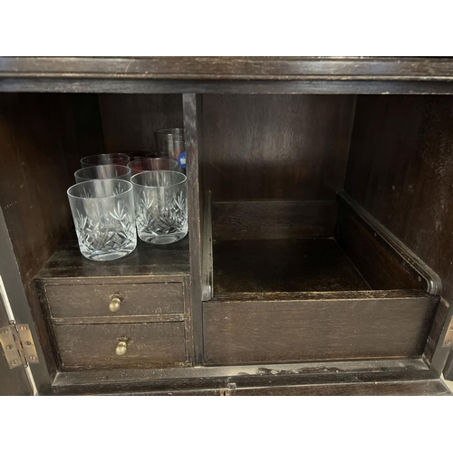 1348 - A vintage dark wood drinks/cocktail cabinet with glass and bottle compartments, 2 drawers and a coll... 