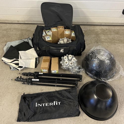 1284 - An Interfit professional photography light set up. In a large carry holdall. Lot includes light head... 