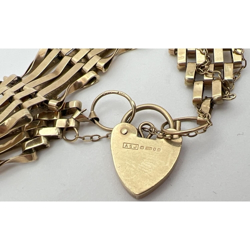 1005 - A 9ct gold 5 bar gate bracelet with heart shaped padlock clasp and safety chain. Fully hallmarked to... 