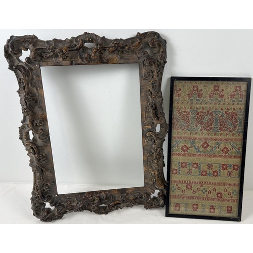 1293 - A framed and glazed antique embroidered panel depicting floral and column design. Together with an a... 