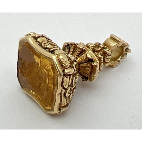 1075 - A Victorian unmarked 9ct gold and citrine seal fob with carved crest to citrine stone and decorative...