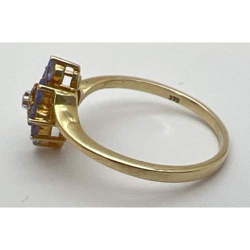 1 - A 9ct gold, tanzanite and diamond dress ring with a cluster setting. Central diamond surrounded by 8... 