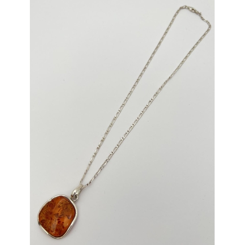 2 - A 925 silver and amber pendant of modern design, on an 18