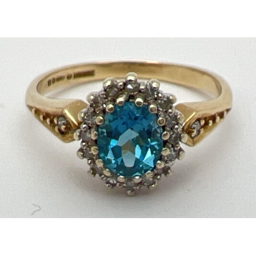 7 - A 9ct gold, London blue topaz and diamond ring in a halo setting. Central oval cut topaz (approx. 6m...