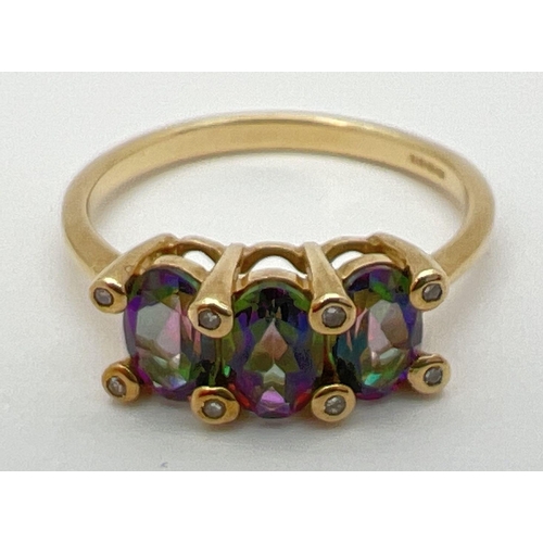 8 - A 9ct yellow gold, mystic topaz and diamond trilogy ring. 3 oval cut mystic topaz stones (each appro... 