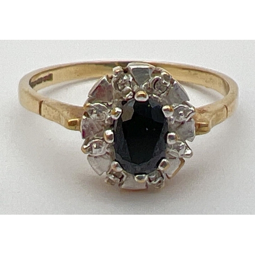 24 - A 9ct gold sapphire and diamond dress ring. Central oval cut sapphire with 4 small diamonds in an il... 