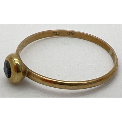 29 - A small vintage 8ct gold ring with a bezel set sapphire. Stamped 333 inside band, ring size M½.