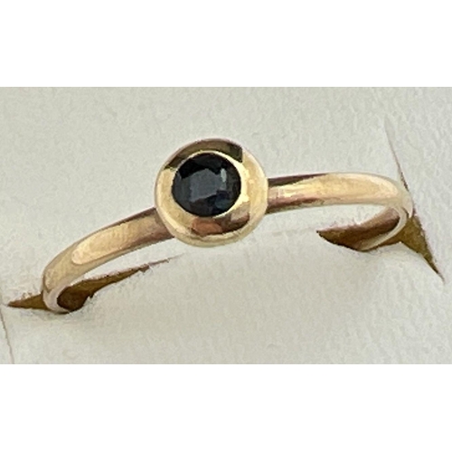 29 - A small vintage 8ct gold ring with a bezel set sapphire. Stamped 333 inside band, ring size M½.