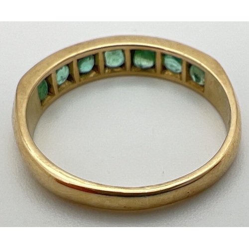 31 - A vintage 9ct gold eternity ring set with 7 round cut emeralds. Fully hallmarked inside band. Ring s... 