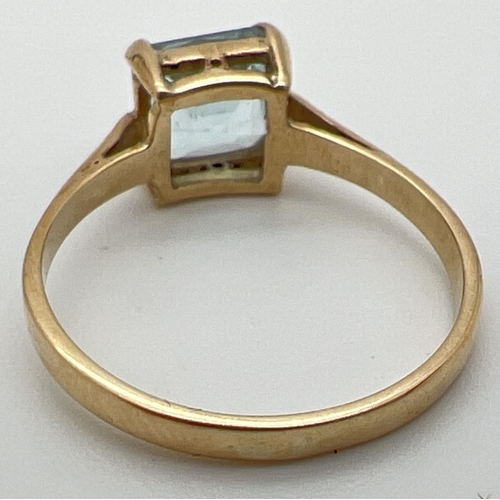 32 - A vintage 9ct gold dress ring set with large square cut blue topaz stone. Stamped 9ct inside band, r... 