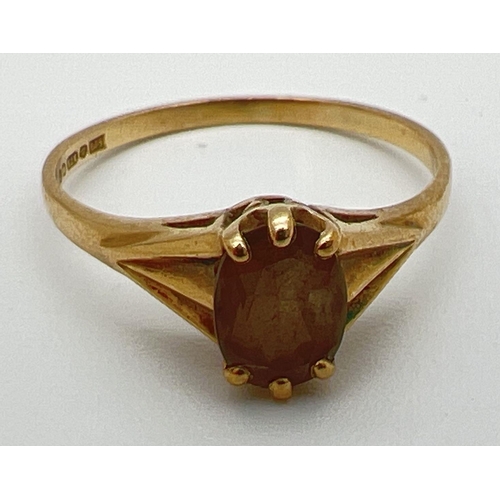 43 - A vintage 9ct gold dress ring set with central oval cut smoked quartz. With claw setting and decorat... 