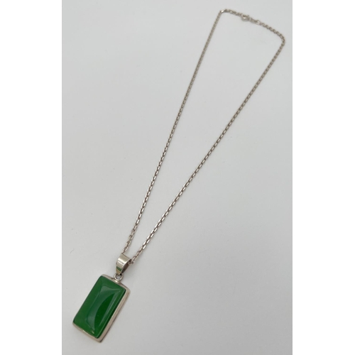 45 - A rectangular shaped apple green jade and 925 silver pendant necklace. Pendant on an 18