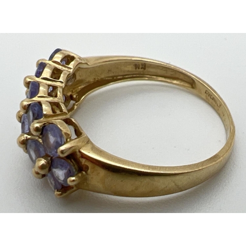 48 - A 9ct yellow gold dress ring set with 3 rows of tanzanite stones. Stamped 9k and 375 inside band. Ri... 