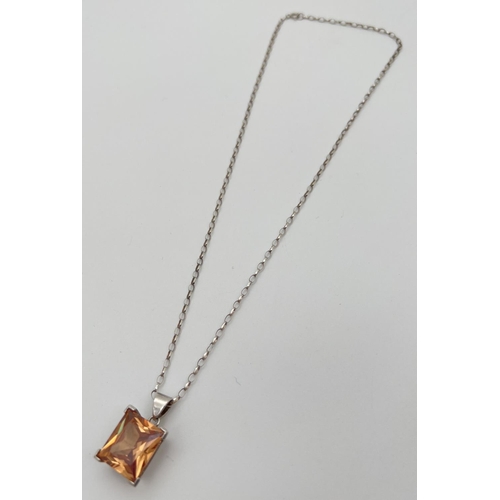 49 - A modern 925 silver pendant necklace with a large princess cut orange coloured stone pendant. Stampe... 