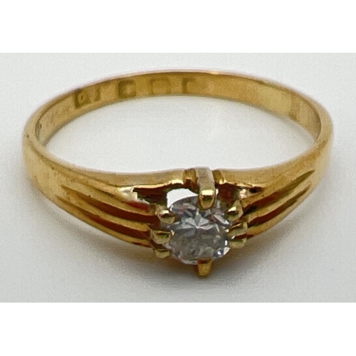 63 - A vintage 22ct gold .25 ct diamond solitaire ring with claw setting and channelled design to shoulde... 