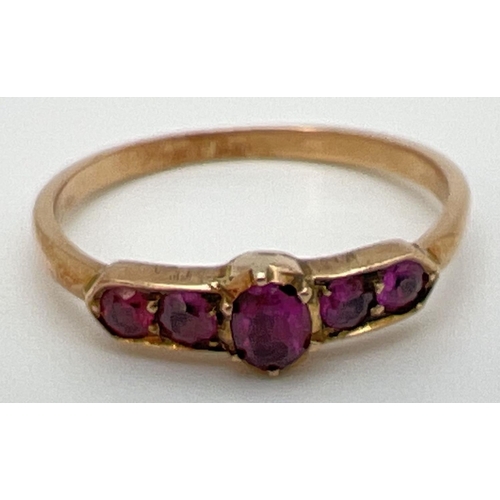 64 - A vintage Art Deco unmarked 18ct gold and amethyst ring. Central oval cut stone flanked by 2 pairs o... 