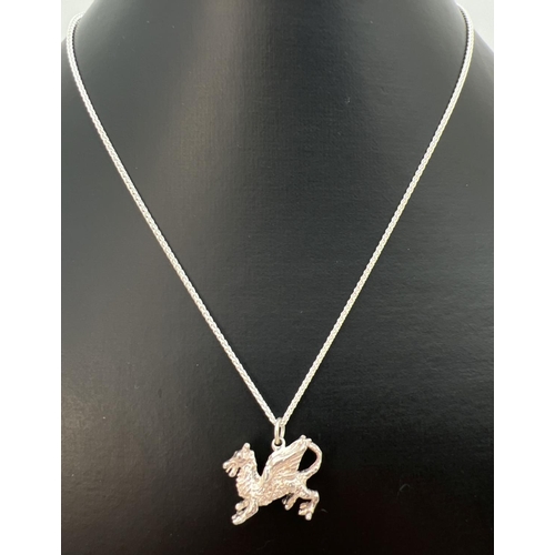 69 - A white metal pendant modelled as a dragon, on an 18