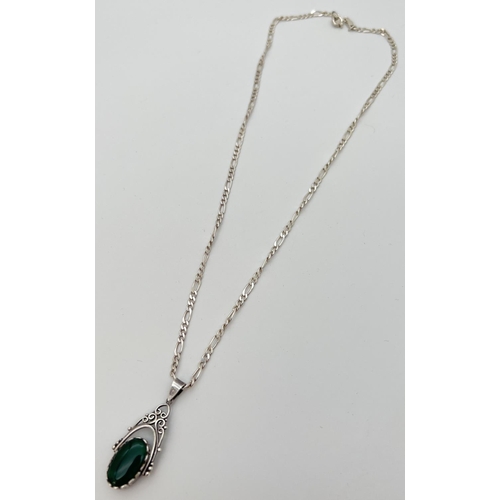 82 - A silver rotating fob pendant set with onyx and green stone on an 20