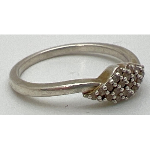 84 - A 925 silver and diamond cluster ring with a diamond shaped mount. Stamped 925 inside band, ring siz... 