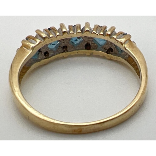 88 - A 9ct gold eternity ring set with 5 square cut London blue topaz stones interspersed with small diam... 