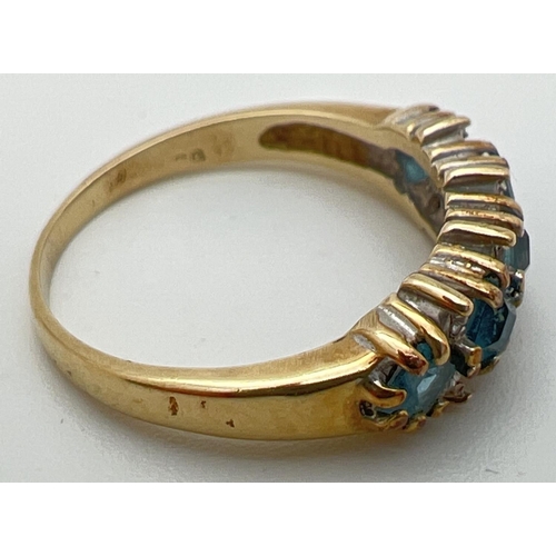 88 - A 9ct gold eternity ring set with 5 square cut London blue topaz stones interspersed with small diam... 