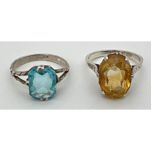 99 - 2 silver large stone set rings. An oval cut citrine (approx. 14mm x 10mm) together with a cushion cu... 