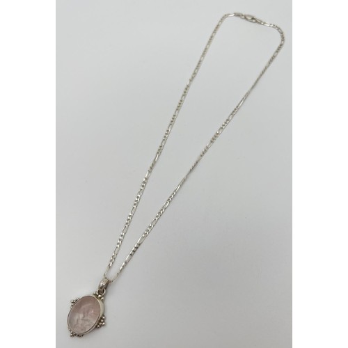 41 - A rose quartz pendant in a silver mount, on an 18