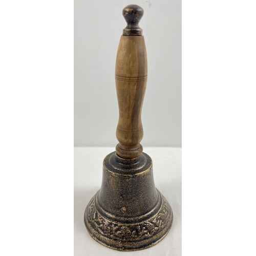 1148 - A wooden handled cast metal hand bell, approx. 28cm tall.