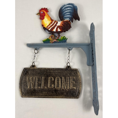 1156 - A painted cast iron wall hanging garden welcome sign with cockerel decoration. Approx. 45cm tall.