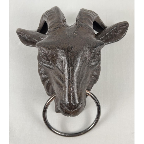 1155 - A cast iron wall hanging ornament modelled of a rams head with a ring. With fixing holes to reverse.... 