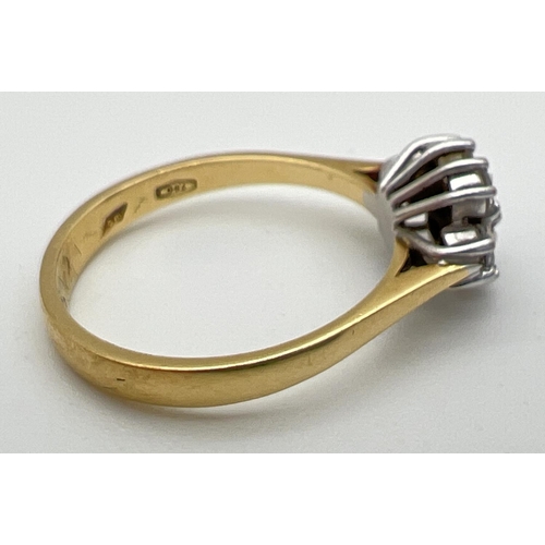 1002 - An 18ct gold and diamond ring. with 7 round cut diamonds in a flower shaped setting, totalling .35ct... 