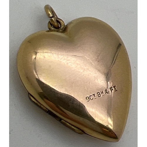 1004 - A vintage 9ct gold front and back heart shaped locket with half floral engraved decoration to front.... 