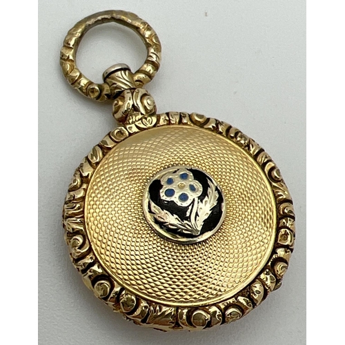 1047 - An Edwardian gold locket with floral design and engine turned detail. Central flower detail to front... 