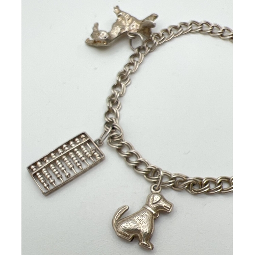 1050 - A vintage silver double curb chain charm bracelet with padlock and safety chain and 4 silver & white... 