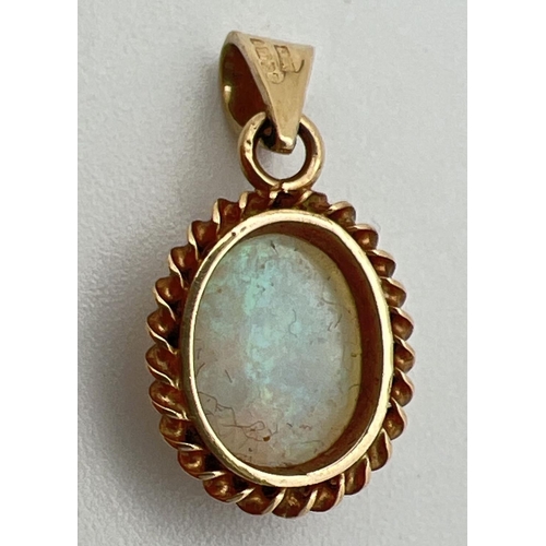 1060 - A 9ct gold cameo style carved opal pendant. Oval pendant with rope design to edge of mount. Classic ... 