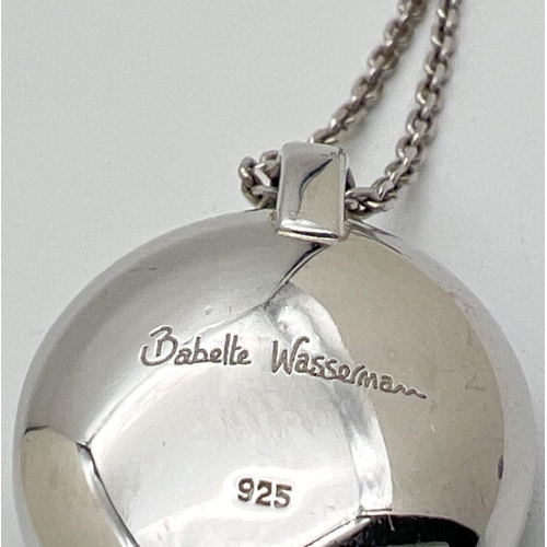 1062 - A designer silver pendant necklace by Babette Wasserman. An oval shaped pendant set with a large mir... 