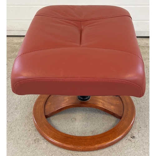 1392 - A modern Verikon rust coloured leather topped sloped footstool with circular shaped wooden base. App... 