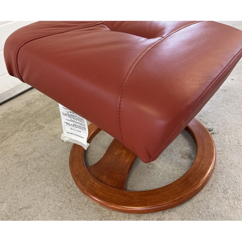 1392 - A modern Verikon rust coloured leather topped sloped footstool with circular shaped wooden base. App... 