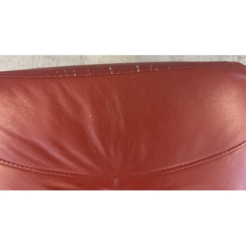 1392 - A modern Verikon rust coloured leather topped sloped footstool with circular shaped wooden base. App... 