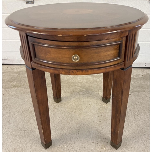 1393 - A modern circular shaped drum table raised on 4 squared shaped tapered legs and with central draw. I... 