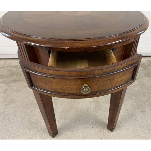 1393 - A modern circular shaped drum table raised on 4 squared shaped tapered legs and with central draw. I... 